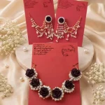 Dark rose and pearl necklace paired with matching dangling pearl earrings