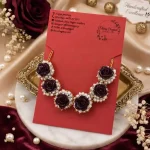 Dark rose and pearl necklace paired with matching dangling pearl earrings